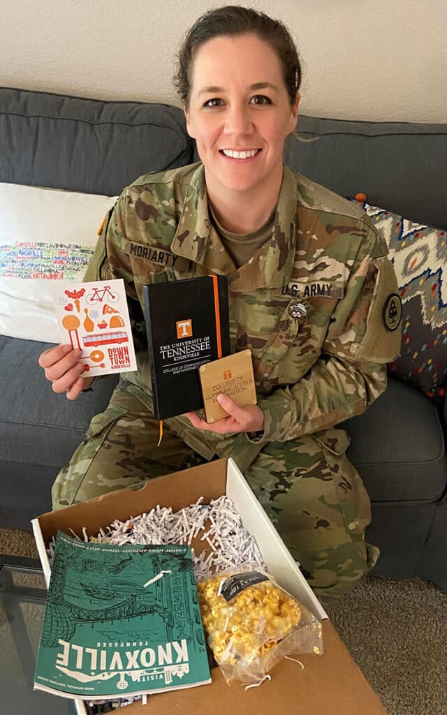 online student Kealy Moriarty opens swag bag from utk