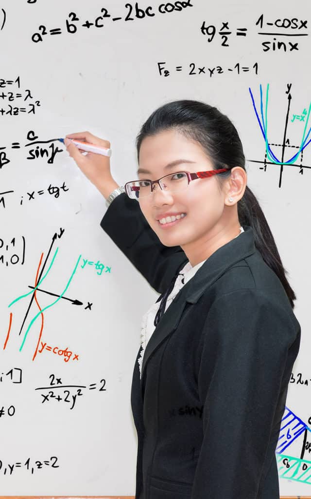asian professor with glasses working on mathematical equations on white board