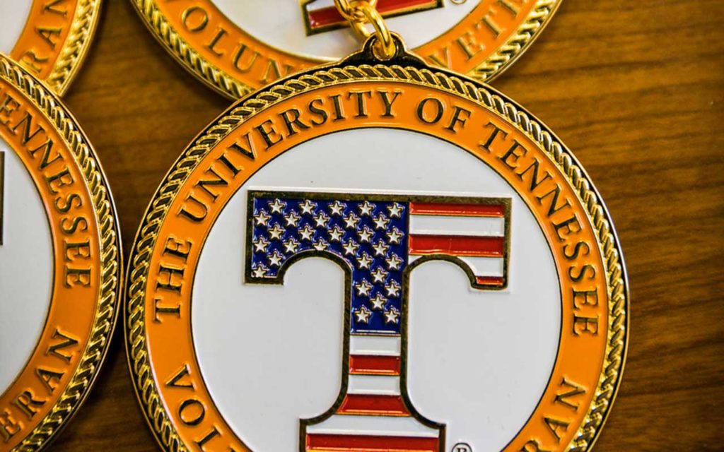 round medal with the university of Tennessee written around large american flag T