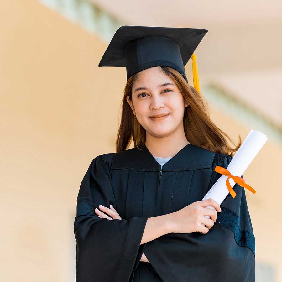 woman in graduation attire smiling